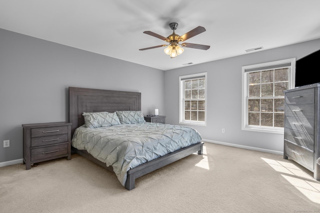 bedroom featuring baseboards, light colored carpet, and ceiling fan