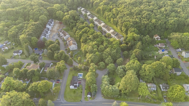 aerial view of property's location featuring a forest