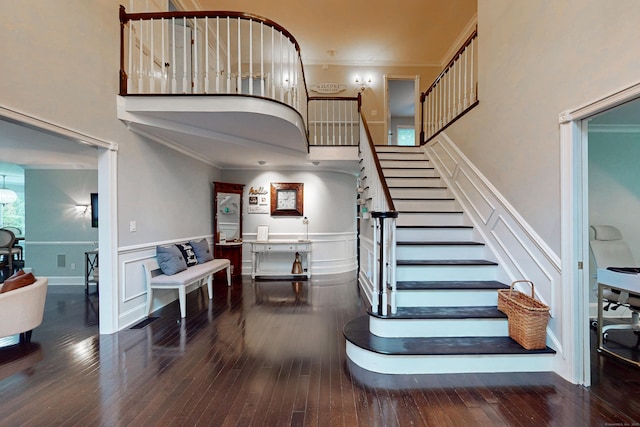 3 Inwood Ln, Woodbury, CT 06798 - staircase featuring ornamental molding, a decorative wall, hardwood / wood-style floors, and a towering ceiling