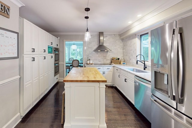 3 Inwood Ln, Woodbury, CT 06798 - kitchen with appliances with stainless steel finishes, butcher block countertops, wall chimney exhaust hood, crown molding, and healthy amount of natural light