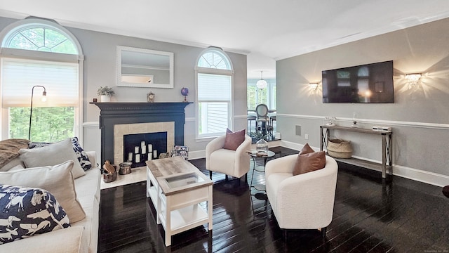 3 Inwood Ln, Woodbury, CT 06798 - living area featuring wood-type flooring, healthy amount of natural light, a tiled fireplace, and ornamental molding
