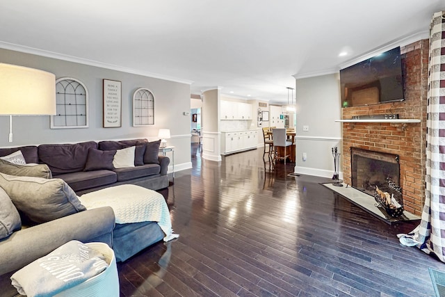 3 Inwood Ln, Woodbury, CT 06798 - living area with ornamental molding, recessed lighting, dark wood finished floors, and a brick fireplace