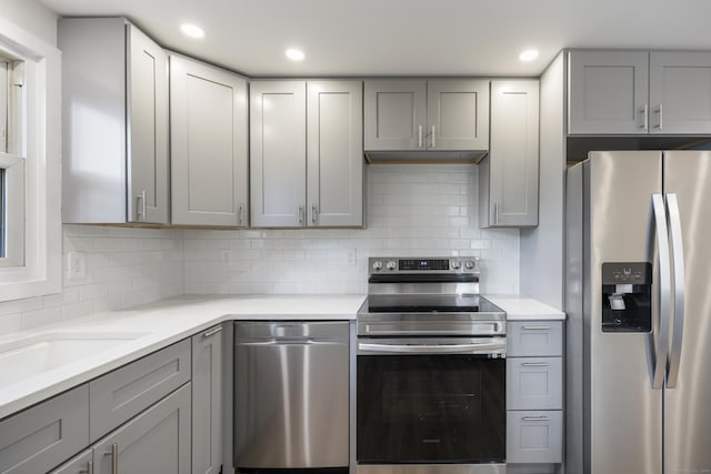 53 Kalish Ave, Enfield, CT 06082 - kitchen featuring stainless steel appliances, gray cabinetry, decorative backsplash, and recessed lighting