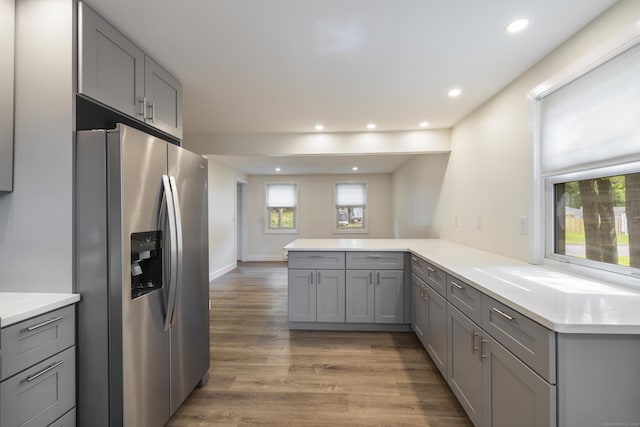 53 Kalish Ave, Enfield, CT 06082 - kitchen with stainless steel fridge with ice dispenser, gray cabinetry, a peninsula, light wood-style flooring, and light countertops