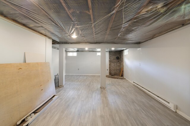 53 Kalish Ave, Enfield, CT 06082 - basement with a baseboard heating unit and light wood-style floors