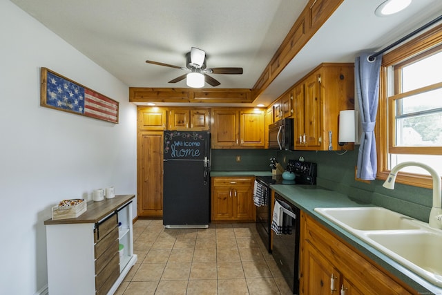 49 First Ave, Enfield, CT 06082 - kitchen with black appliances, a sink, brown cabinetry, a ceiling fan, and light tile patterned floors
