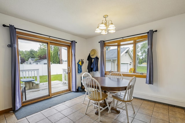 49 First Ave, Enfield, CT 06082 - dining space featuring a chandelier, light tile patterned floors, and baseboards