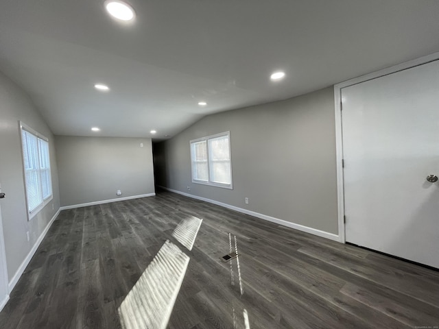 66 Nancy Ln, Naugatuck, CT 06770 - unfurnished living room with lofted ceiling, dark wood finished floors, recessed lighting, and baseboards