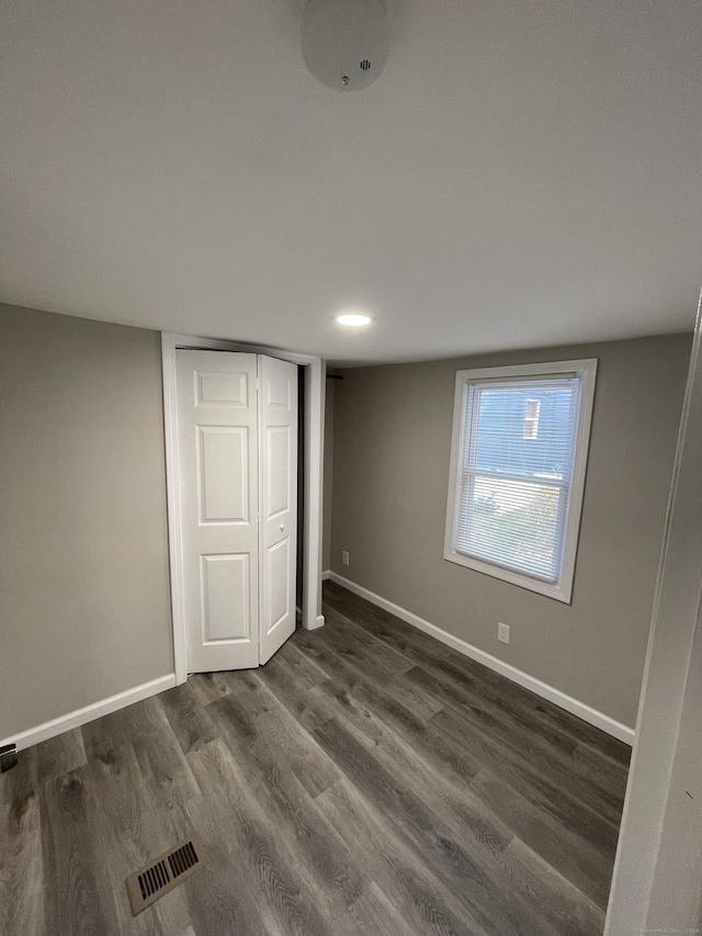 66 Nancy Ln, Naugatuck, CT 06770 - unfurnished bedroom with dark wood-type flooring, baseboards, and a closet