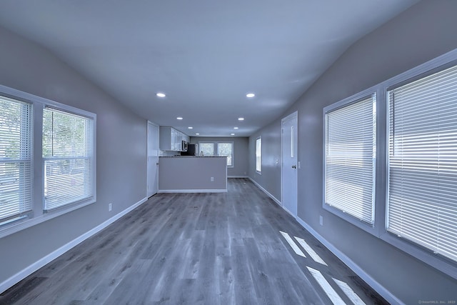 66 Nancy Ln, Naugatuck, CT 06770 - unfurnished living room featuring healthy amount of natural light, recessed lighting, dark wood-style floors, baseboards, and lofted ceiling