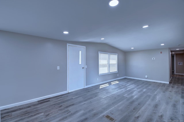 66 Nancy Ln, Naugatuck, CT 06770 - unfurnished living room featuring lofted ceiling, baseboards, wood finished floors, and recessed lighting