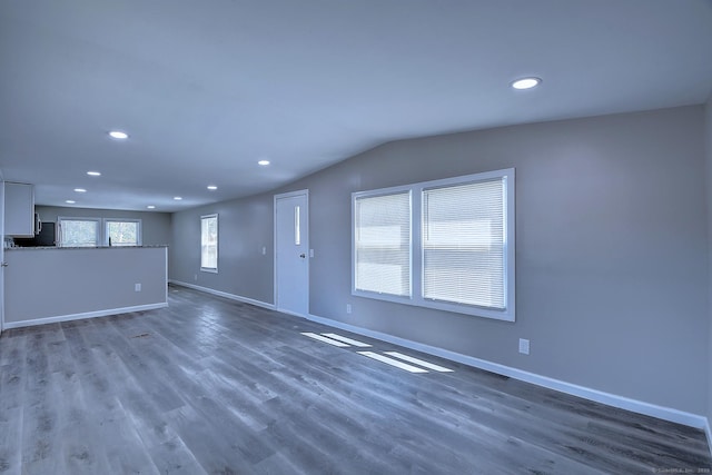 66 Nancy Ln, Naugatuck, CT 06770 - unfurnished living room featuring baseboards, recessed lighting, dark wood finished floors, and vaulted ceiling