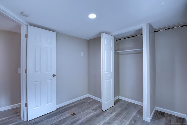 66 Nancy Ln, Naugatuck, CT 06770 - unfurnished bedroom featuring wood finished floors, baseboards, a closet, and recessed lighting