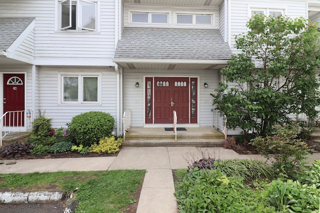 678 Savin Ave Apt 2J, West Haven, CT 06516 - view of exterior entry featuring roof with shingles
