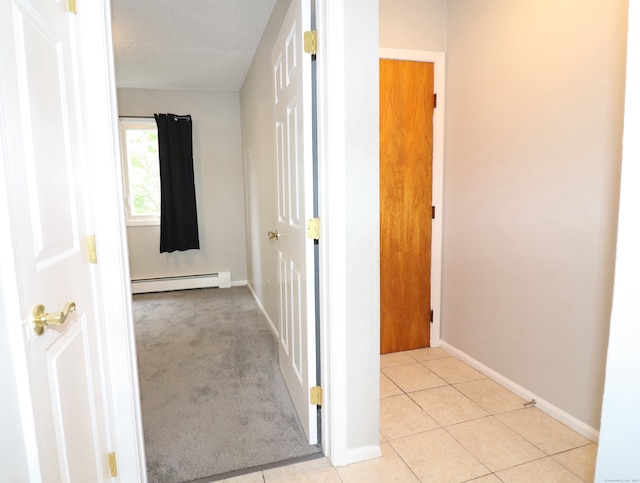 678 Savin Ave Apt 2J, West Haven, CT 06516 - hall with a baseboard heating unit, baseboards, and light tile patterned floors