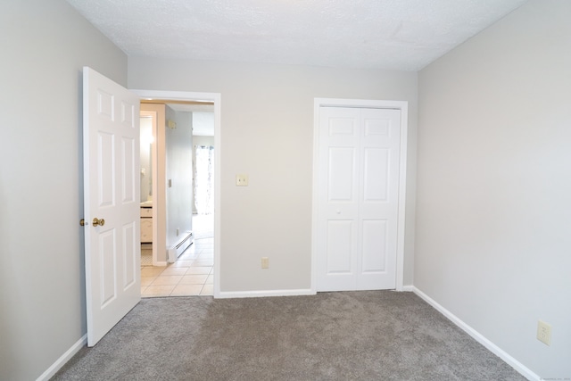 678 Savin Ave Apt 2J, West Haven, CT 06516 - unfurnished bedroom featuring baseboard heating, light carpet, a closet, and baseboards