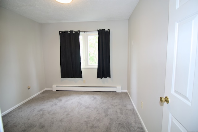 678 Savin Ave Apt 2J, West Haven, CT 06516 - spare room featuring a baseboard heating unit, carpet, baseboards, and a textured ceiling