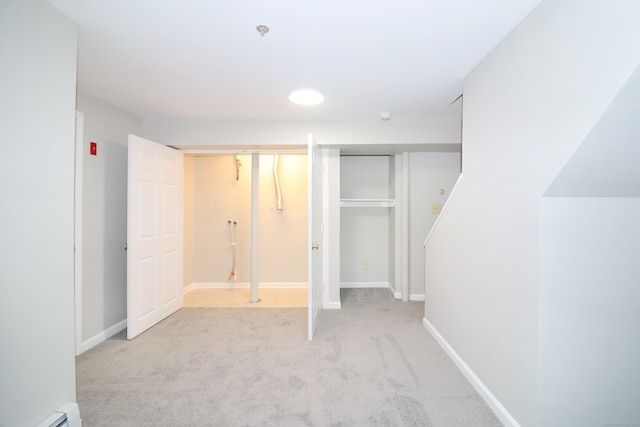 678 Savin Ave Apt 2J, West Haven, CT 06516 - unfurnished bedroom featuring a baseboard radiator, light colored carpet, and baseboards