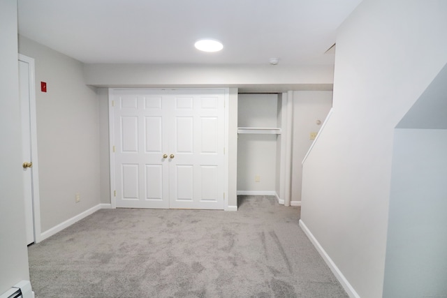 678 Savin Ave Apt 2J, West Haven, CT 06516 - unfurnished bedroom with a baseboard heating unit, carpet flooring, and baseboards