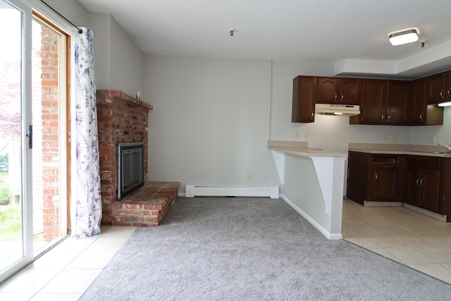 678 Savin Ave Apt 2J, West Haven, CT 06516 - kitchen featuring under cabinet range hood, a baseboard radiator, healthy amount of natural light, and light colored carpet