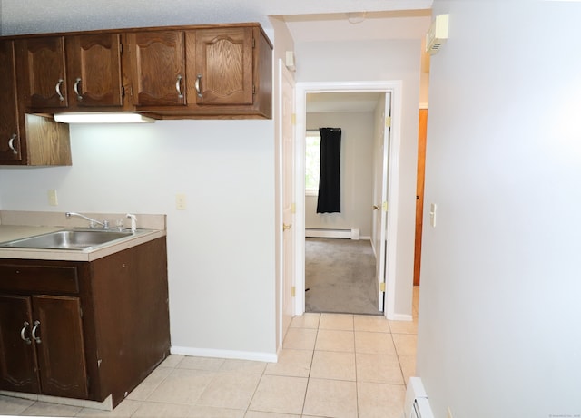 678 Savin Ave Apt 2J, West Haven, CT 06516 - kitchen with a sink, baseboard heating, light countertops, light tile patterned floors, and baseboards