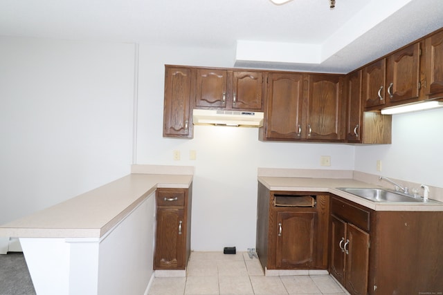 678 Savin Ave Apt 2J, West Haven, CT 06516 - kitchen with under cabinet range hood, a sink, a peninsula, and light countertops