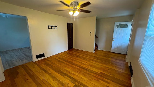 125 Lebanon St, Hartford, CT 06112 - unfurnished room with wood-type flooring, stairs, a ceiling fan, and baseboards