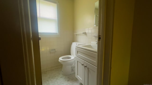 125 Lebanon St, Hartford, CT 06112 - half bath featuring tile walls, vanity, toilet, and wainscoting