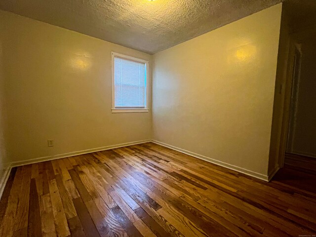 125 Lebanon St, Hartford, CT 06112 - empty room featuring dark wood-style floors, a textured ceiling, and baseboards