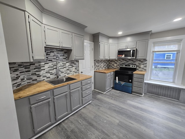 11 Caya Ave, West Hartford, CT 06110 - kitchen with range with electric stovetop, wooden counters, stainless steel microwave, gray cabinets, and a sink
