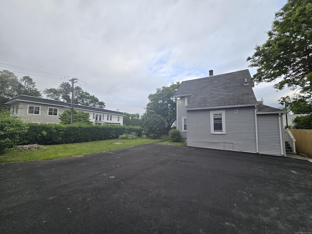 11 Caya Ave, West Hartford, CT 06110 - view of property exterior with asphalt driveway and roof with shingles