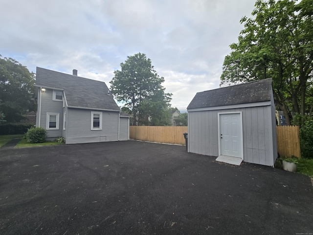 11 Caya Ave, West Hartford, CT 06110 - view of side of home featuring an outbuilding, fence, a storage unit, and driveway