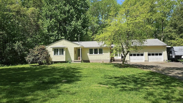 ranch-style home with an attached garage, a front lawn, and driveway