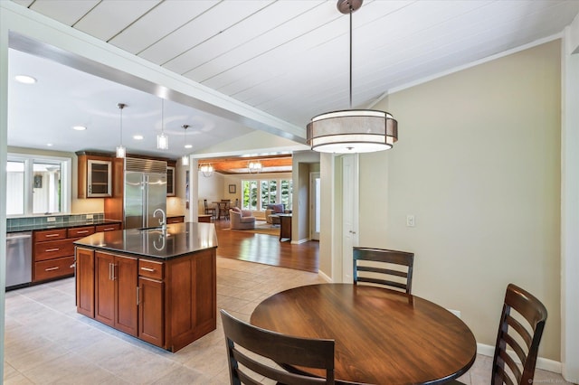 7 Sugar Loaf Cut, Simsbury, CT 06092 - kitchen with appliances with stainless steel finishes, dark countertops, open floor plan, glass insert cabinets, and an island with sink