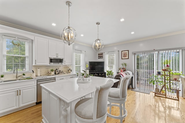1095 Hope St Unit B, Stamford, CT 06907 - kitchen with a sink, appliances with stainless steel finishes, light countertops, healthy amount of natural light, and ornamental molding