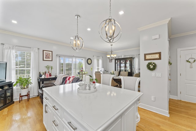 1095 Hope St Unit B, Stamford, CT 06907 - kitchen featuring a chandelier, light wood-style floors, white cabinetry, light countertops, and crown molding