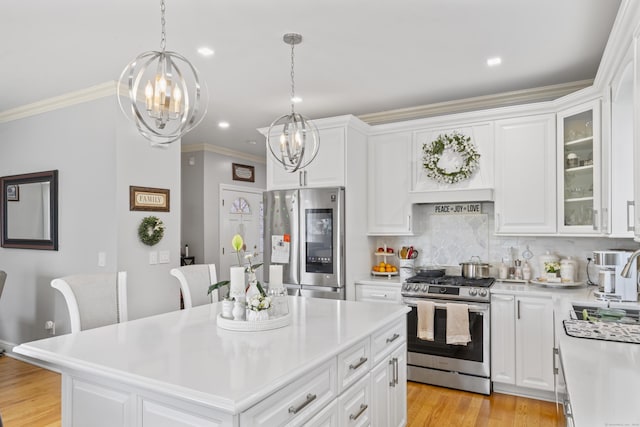 1095 Hope St Unit B, Stamford, CT 06907 - kitchen with appliances with stainless steel finishes, a chandelier, light countertops, ornamental molding, and decorative backsplash