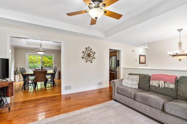 114 Ives Ave, Meriden, CT 06450 - living room featuring wood finished floors, a raised ceiling, a ceiling fan, and baseboards