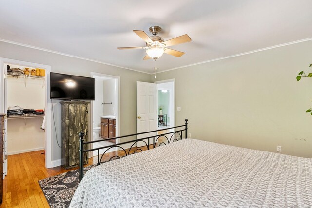 114 Ives Ave, Meriden, CT 06450 - bedroom featuring a spacious closet, hardwood / wood-style flooring, a closet, baseboards, and ornamental molding