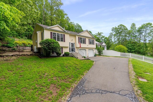 114 Ives Ave, Meriden, CT 06450 - split foyer home with asphalt driveway and an attached garage