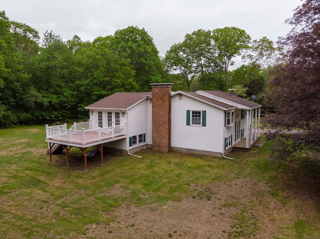 29 Ralph St, Plainfield, CT 06354 - rear view of house featuring a deck, a chimney, and a lawn