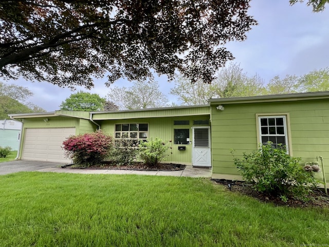 265 Marina Dr, Stratford, CT 06614 - view of front facade featuring an attached garage, driveway, and a front lawn
