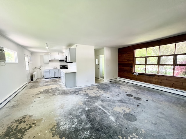 265 Marina Dr, Stratford, CT 06614 - unfurnished living room featuring plenty of natural light, a baseboard radiator, and unfinished concrete flooring