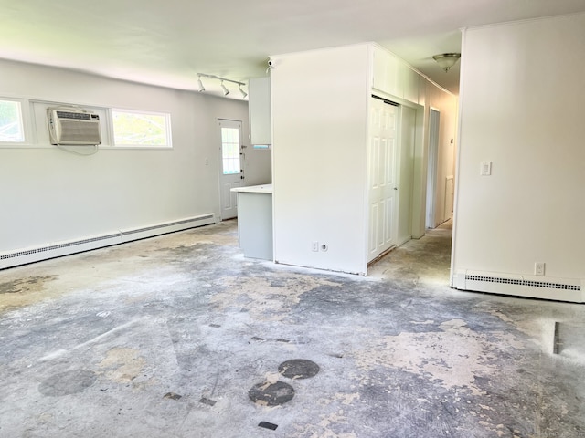 265 Marina Dr, Stratford, CT 06614 - empty room with baseboard heating, a wall mounted AC, and unfinished concrete flooring