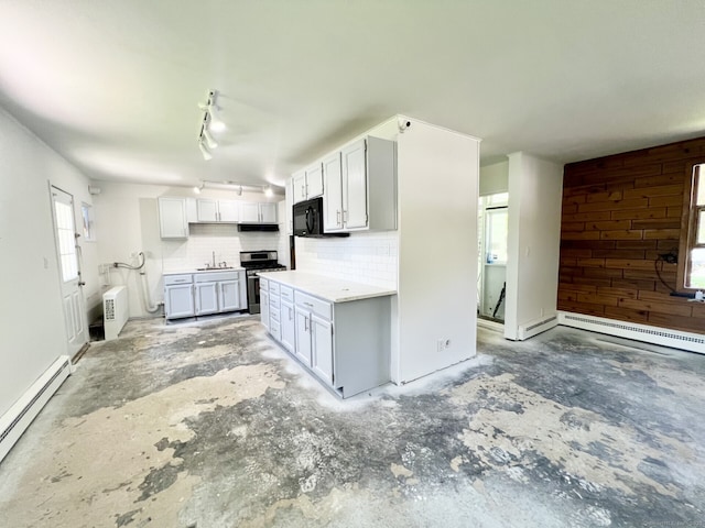 265 Marina Dr, Stratford, CT 06614 - kitchen with stainless steel range with gas stovetop, baseboard heating, a sink, black microwave, and backsplash