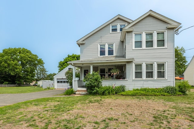 16 Reservoir Rd, Vernon, CT 06066 - view of front of house with a front yard, covered porch, an outdoor structure, a garage, and asphalt driveway