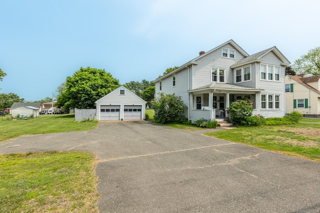 16 Reservoir Rd, Vernon, CT 06066 - view of front of home with an outbuilding, a detached garage, a front yard, a chimney, and a porch