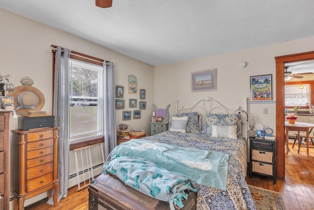 16 Reservoir Rd, Vernon, CT 06066 - bedroom featuring multiple windows, hardwood / wood-style flooring, and a baseboard heating unit