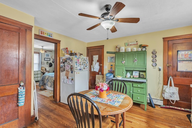 16 Reservoir Rd, Vernon, CT 06066 - dining area featuring a ceiling fan, light wood-style flooring, and a baseboard heating unit