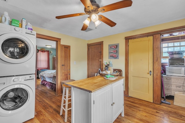 16 Reservoir Rd, Vernon, CT 06066 - laundry area with stacked washing machine and dryer, light wood-style floors, and ceiling fan